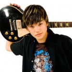 Portrait of teenage boy holding guitar